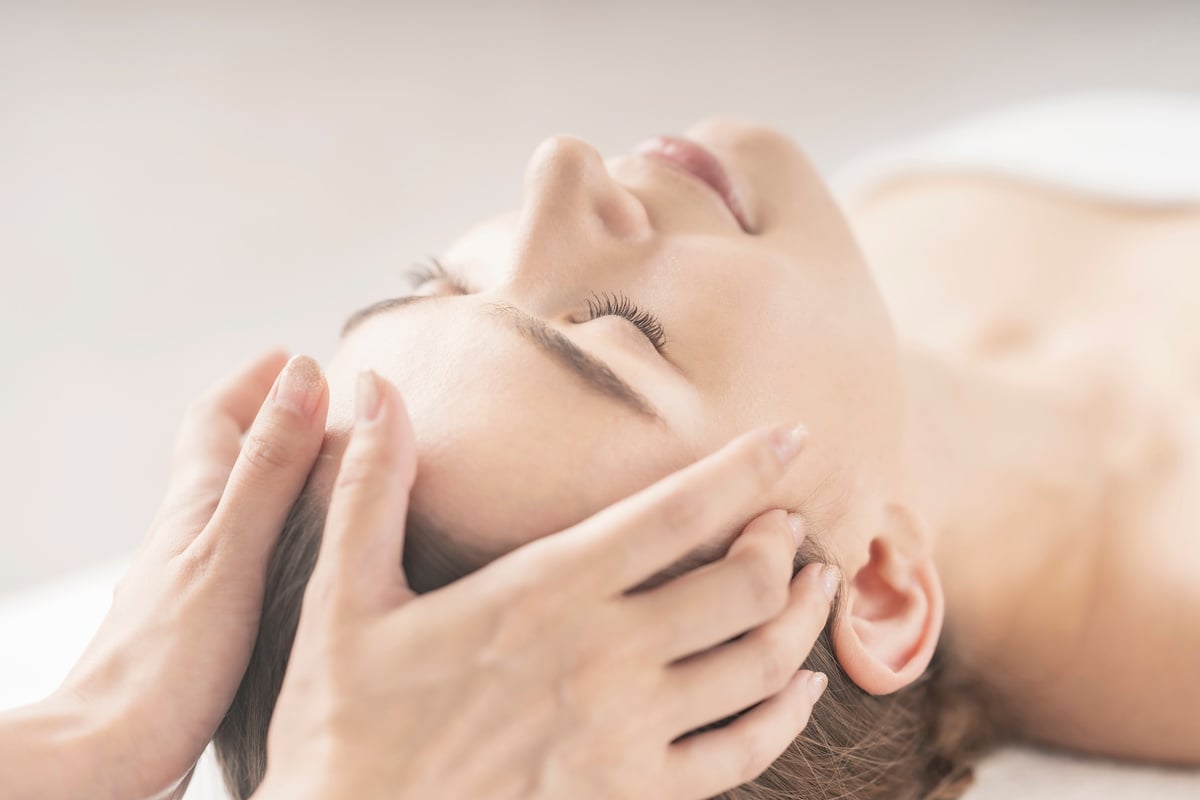 Young woman having her head massaged