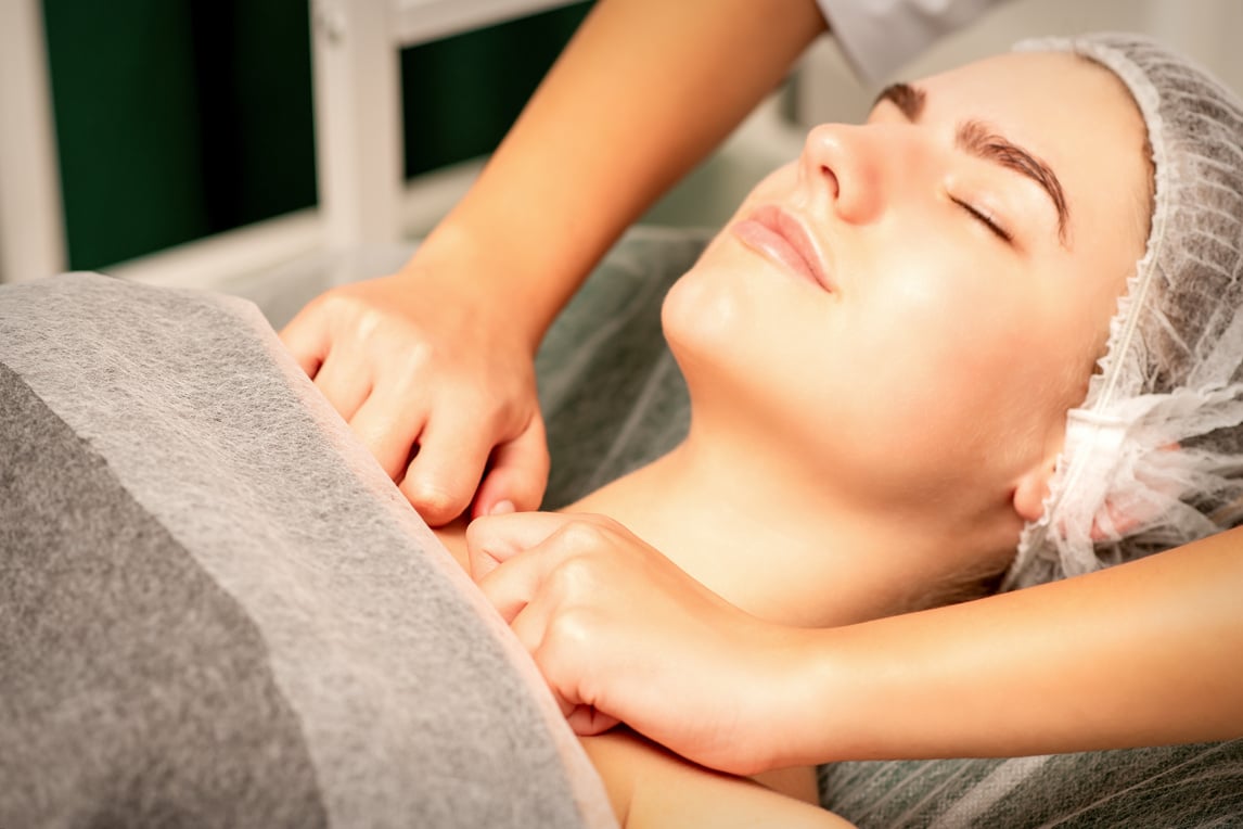 Massaging Female Breast, and Shoulder. Young Beautiful Caucasian Woman with Closed Eyes Receiving Chest and Shoulders Massage in Beauty Spa Salon.